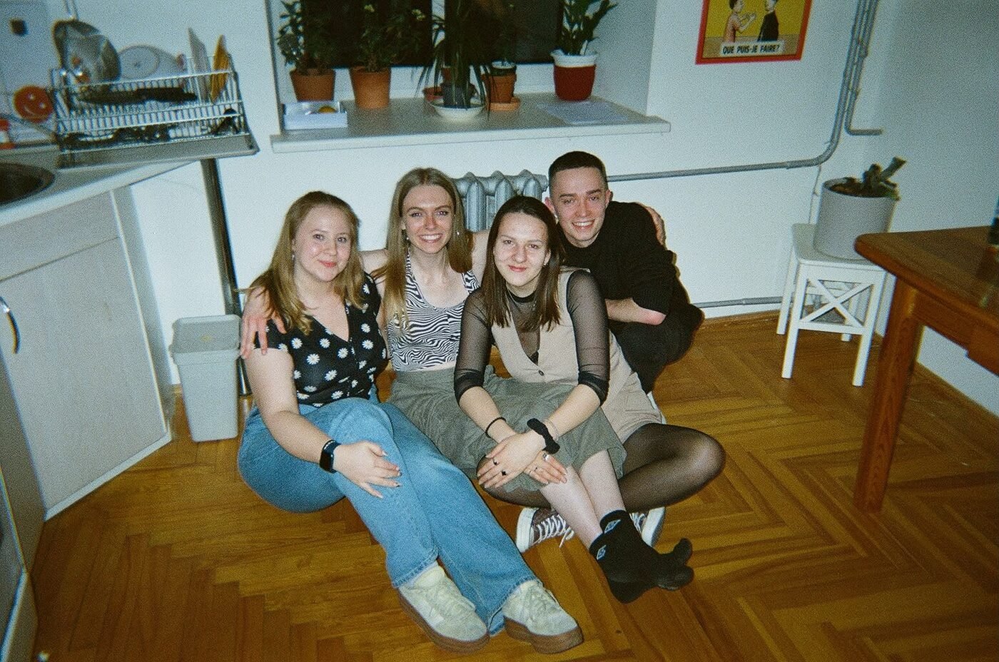 Urtė sitting on the floor with friends